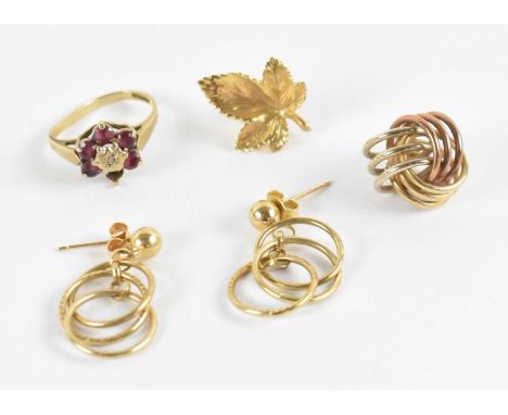 A pair of 9ct yellow gold earrings, each suspending three small hoops, a 9ct yellow gold maple leaf earring and a further 9ct