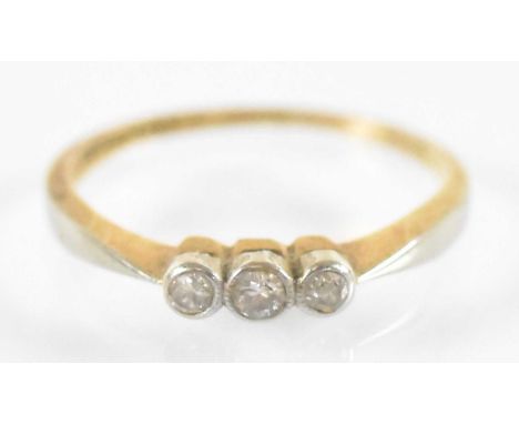 An 18ct yellow gold and platinum three stone diamond ring, size K, approx 1.6g.