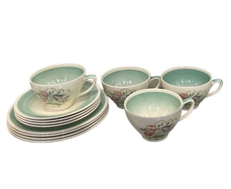 SUSIE COOPER; a part tea service, floral decoarated, comprising four teacups, four saucers and four side plates.