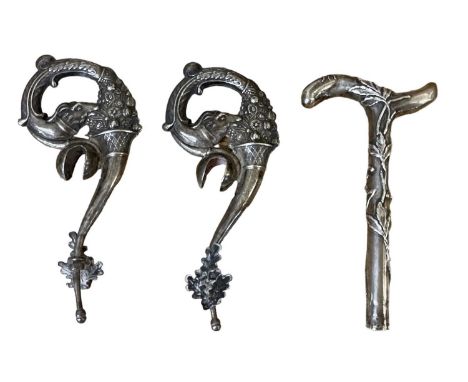A miniature white metal walking stick or parasol handle, decorated with scrolling foliage and ladybirds, height 10cm, and two