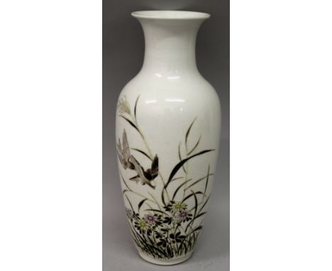 A CHINESE FAMILLE ROSE PORCELAIN VASE, decorated with calligraphy and with two birds in flight above flowers and grass, the b