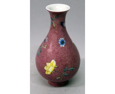 A CHINESE FAMILLE ROSE PINK GROUND PORCELAIN VASE, the sides decorated with floral sprays reserved on a sgraffiato incised gr