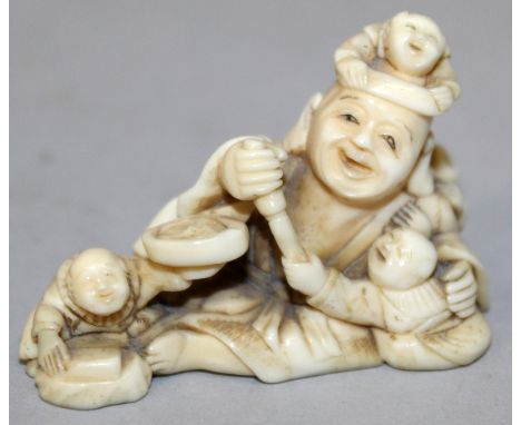 A GOOD QUALITY JAPANESE MEIJI PERIOD IVORY NETSUKE OF HOTEI, the reclining deity in the company of four small boys, the detai