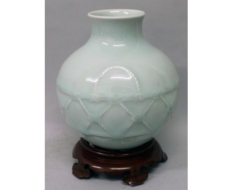 A CHINESE CELADON MOULDED VASE, together with a fitted wood stand, the sides of the vase with a formal rope work design, the 