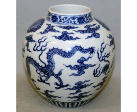 A CHINESE BLUE & WHITE PORCELAIN DRAGON POT, the sides decorated with two dragons amidst cloud and flame scrolls pursuing a f