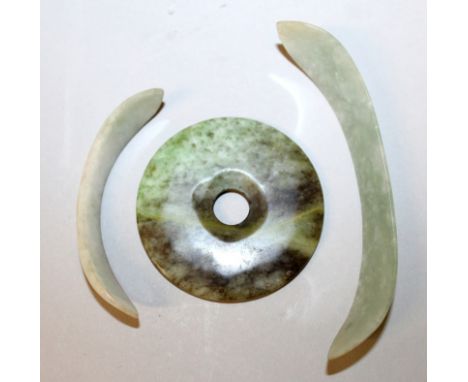 TWO CHINESE JADE HAIR ORNAMENTS, of curving form, 3.8in & 2.7in long; together with a jade Bi disc, 2.2in diameter. (3)