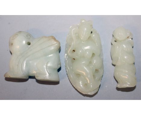 A CHINESE PALE CELADON JADE-LIKE MODEL OF A WINGED PIXIU, 1.8in wide x 1.6in high; together with two further celadon jade-lik