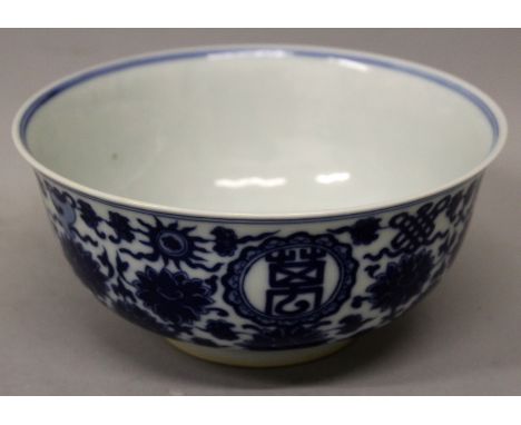 A CHINESE BLUE & WHITE PORCELAIN BOWL, the sides decorated with roundels of auspicious characters and with the Eight Buddhist