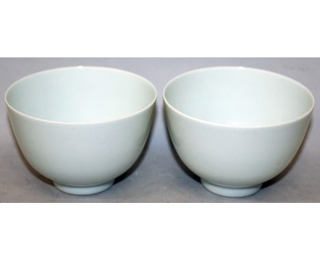 A PAIR OF CHINESE WHITE GLAZED PORCELAIN CUPS, the glaze with a bluish tinge, each base with a Qianlong seal mark, each 3.6in