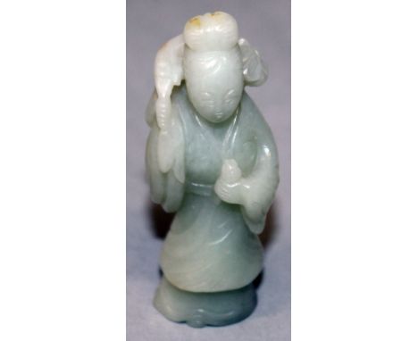 A CHINESE CELADON JADE FIGURE OF A STANDING LADY, dressed in flowing robes and holding a foliate spray over her shoulders, 3.