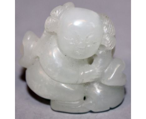 A SMALL CHINESE WHITE JADE MODEL OF A CROUCHING BOY, 1.2in high.
