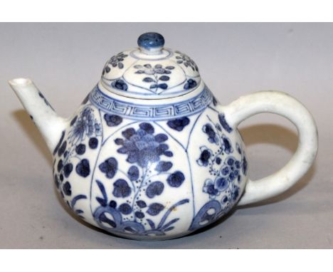 A GOOD CHINESE KANGXI PERIOD BLUE & WHITE SHIPWRECK TEAPOT & COVER, circa 1700, with a variety of barbed floral panels, 5.9in