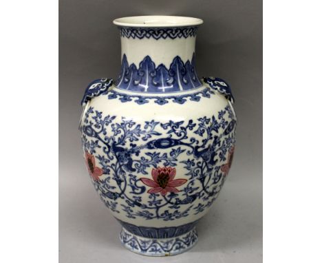 A GOOD QUALITY CHINESE BLUE & WHITE & ENAMELLED PORCELAIN VASE, the sides decorated with a formal design of scrolling lotus, 