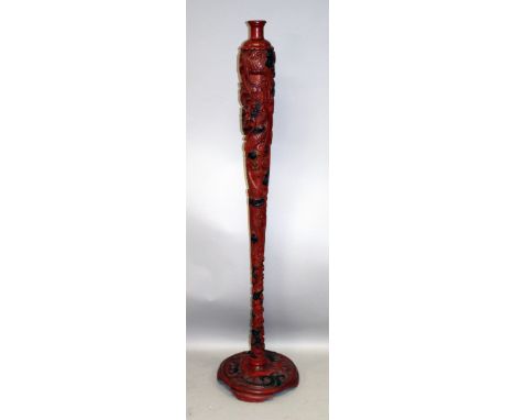 AN UNUSUAL LARGE EARLY 20TH CENTURY JAPANESE RED LACQUERED WOOD LAMP STAND, carved in high and extended relief with a sinuous