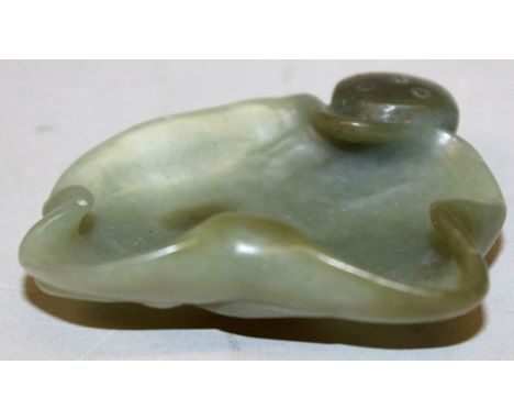 A CHINESE GREEN JADE BRUSHWASHER, in the form of an open lotus leaf, 2.75in x 2.6ins high.