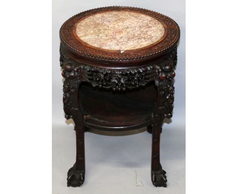 A 19TH CENTURY CHINESE MARBLE TOP CARVED HARDWOOD STAND, the circular shaped top with a foliate scroll border above a pierced
