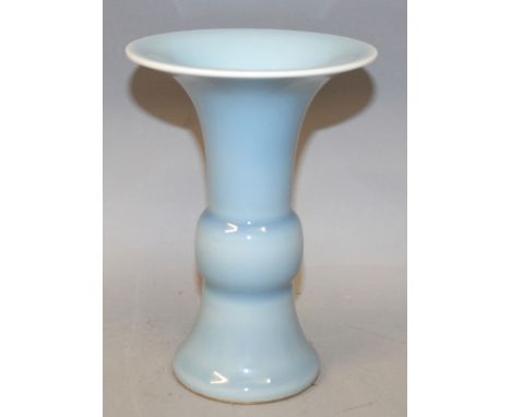 A CHINESE CLAIRE-DE-LUNE PORCELAIN GU VASE, with flaring neck and foot, the base with a Qianlong seal mark, 7in high.