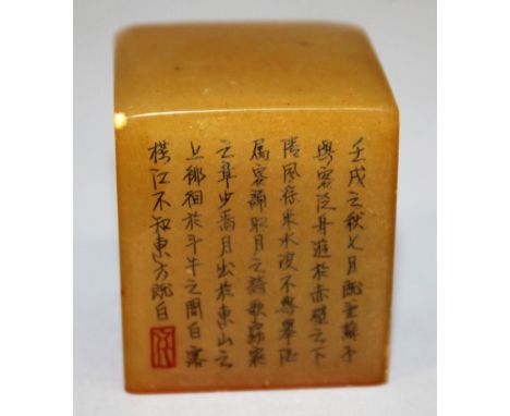 A CHINESE SOAPSTONE SEAL, of cube form, two of the vertical surfaces engraved with black stained calligraphy and a red-staine