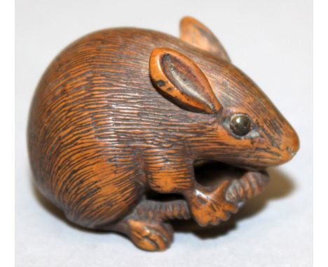 A GOOD QUALITY SIGNED JAPANESE MEIJI PERIOD WOOD NETSUKE OF A RAT, clasping its tail, its eyes inlaid, the base with an engra