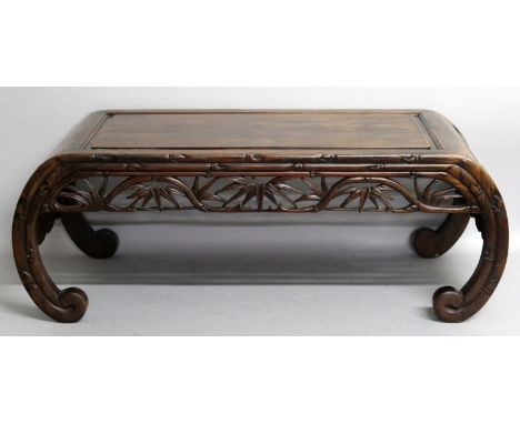 A 19TH/20TH CENTURY CHINESE CARVED HARDWOOD OPIUM TABLE, with inward curving scroll feet, the frieze pierced and carved with 