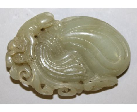 A 19TH/20TH CENTURY CHINESE CELADON PIERCED JADE CARVING, modelled in the form of a monkey upon a large bag clasping a frond 