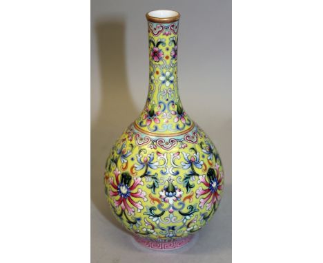 A CHINESE YELLOW GROUND FAMILLE ROSE PORCELAIN BOTTLE VASE, the sides decorated with formal scrolling lotus, the base with a 