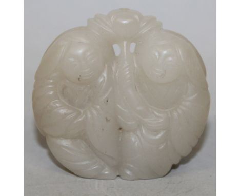 A CHINESE WHITE JADE-LIKE CELADON PENDANT, in the form of the He He Erxian, the head of each boy shrouded by a lotus leaf, on