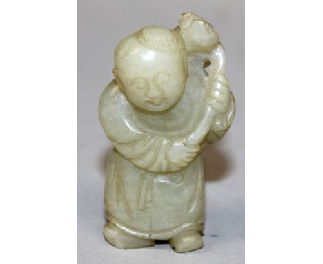 A 19TH CENTURY CHINESE CARVED CELADON JADE FIGURE OF A STANDING BOY, holding a lotus frond in his hands, 2.3in high.