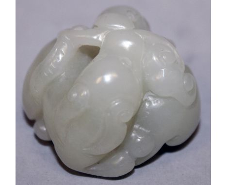 A SMALL CHINESE CELADON GREEN JADE CARVING, in the form of a pair of mythical animals clasping a frond of lingzhi in their mo