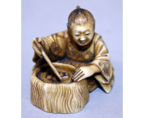 A SMALL GOOD QUALITY SIGNED JAPANESE MEIJI PERIOD OKIMONO OR NETSUKE, carved in the form of a seated boy fanning a hibachi, t
