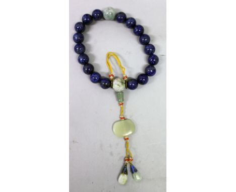 A CHINESE LAPIS-TYPE BRACELET, with spherical beads, the bangle also including a few jade-like beads and pendants, approx. 4.