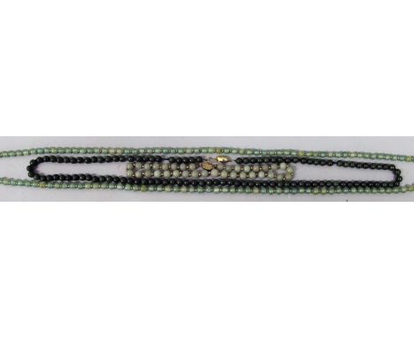 A GROUP OF THREE JADE-LIKE NECKLACES, each composed of spherical beads, the longest approx. 53in long. (3)