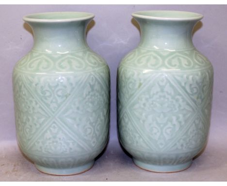 A PAIR OF 20TH CENTURY CHINESE MOULDED CELADON PORCELAIN VASES, each moulded beneath the glaze with diamond and triangular fo