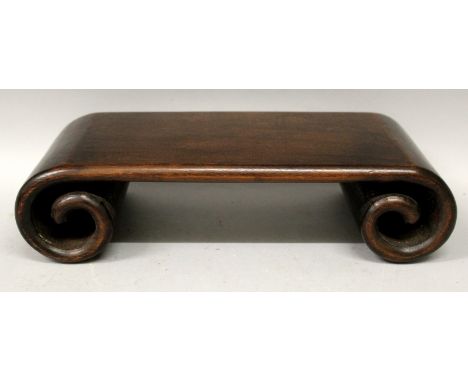 A GOOD 19TH CENTURY CHINESE CARVED HARDWOOD STAND, with scroll end supports, 11.5in wide x 5.75in x 3.1in high.