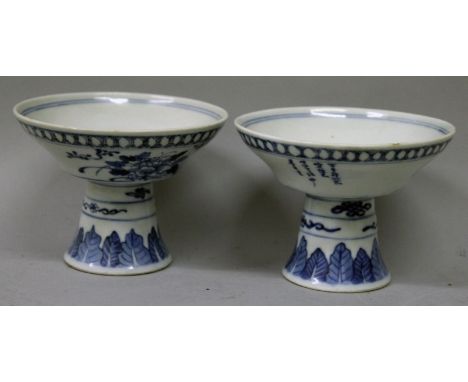 A PAIR OF 19TH CENTURY CHINESE BLUE & WHITE PORCELAIN STEM BOWLS, the flaring sides painted with peony, rockwork and columns 