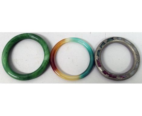 A GROUP OF THREE CHINESE JADE-LIKE BANGLES, the largest 3.25in diameter. (3)