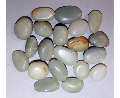 A GROUP OF TWENTY CHINESE CELADON GREEN JADE PEBBLES, of various shapes and sizes, the largest 1.1in wide. (20)