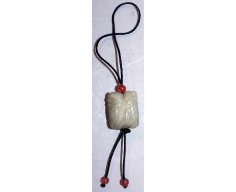 A CHINESE CELADON GREEN JADE PENDANT BEAD, in the form of a pair of cicada, the string with three small agate-type spherical 