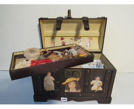 A trunk containing dolls clothes 