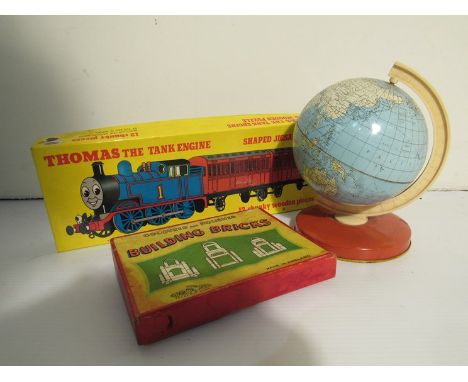 A tinplate globe, Thomas the Tank Engine jigsaw and boxed building bricks 