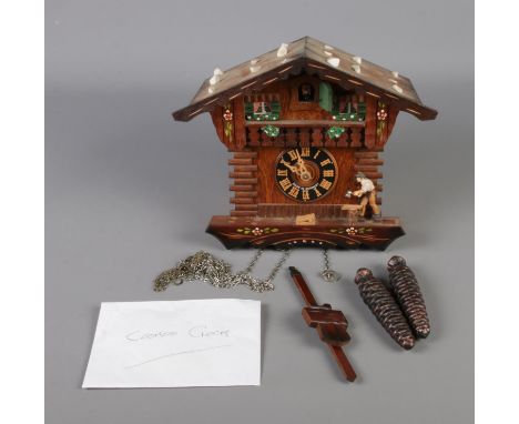 A German Regula pendulum cuckoo clock in the form of a carpenters house.  