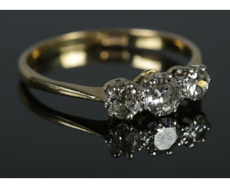 An 18ct Gold and three stone Diamond ring, approximately 0.78 pts. Size R. Total weight: 2.4g.  