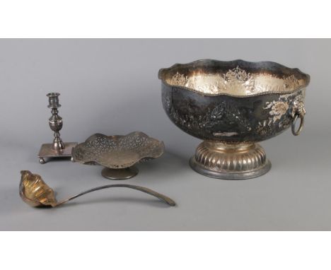 A collection of silver plate including large punch bowl, ladle, candlestick and cake stand.  