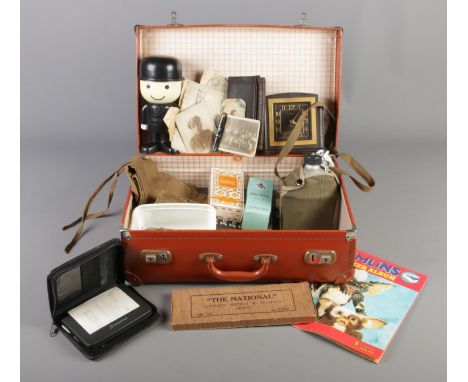 A suitcase of collectables. Includes Smiths bakelite clock, vintage photographs, Conway fountain pen, metal flask stamped Kor