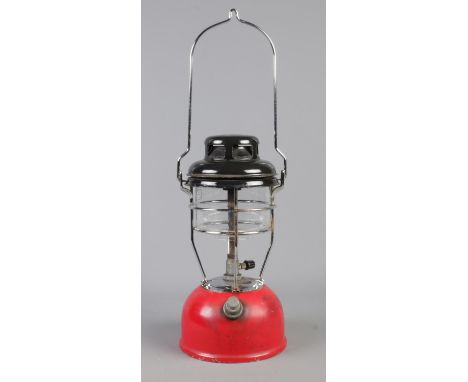 A red based Tilley light. 33cm high (excluding handle).  