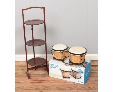 A Sue Ryder boxed Bongo Set and mahogany three tier folding cake stand.  