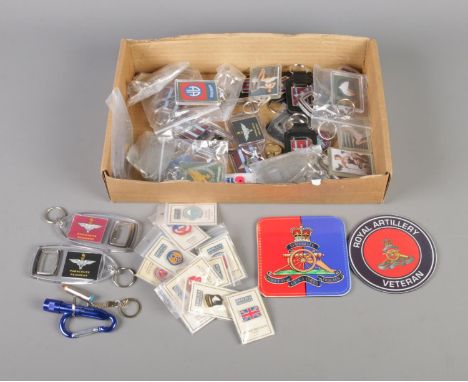 A collection of military themed keyrings and enamel pin badges, including Parachute Regiment and Airborne. Also includes Roya