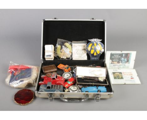A hard shell suitcase containing a good quantity of collectables, to include AA car badge, Michael Jackson concert tickets, G
