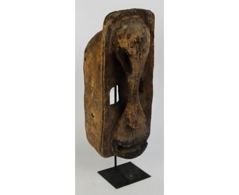 A Dogon mask, Mali, with elephant trunk mask as the nose, length 45.5cm, width 19cm, height 20cm.