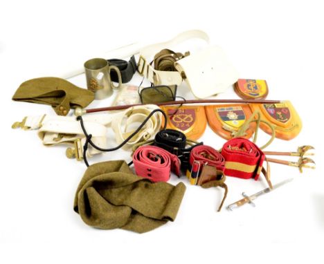 A mixed lot of militaria to include various belts and lanyards, a beret, a pewter mug set with a Royal Artillery badge, shiel